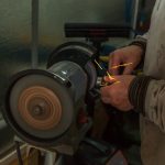 Man using a bench grinder